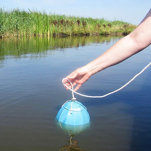 de afbreekbare urn wordt in het water gelaten